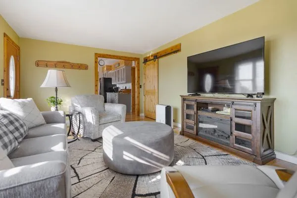 a living room with furniture and a flat screen tv