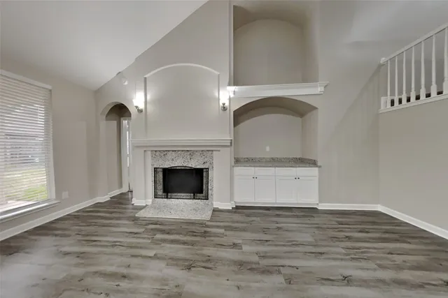 a living room with a fireplace and a fireplace