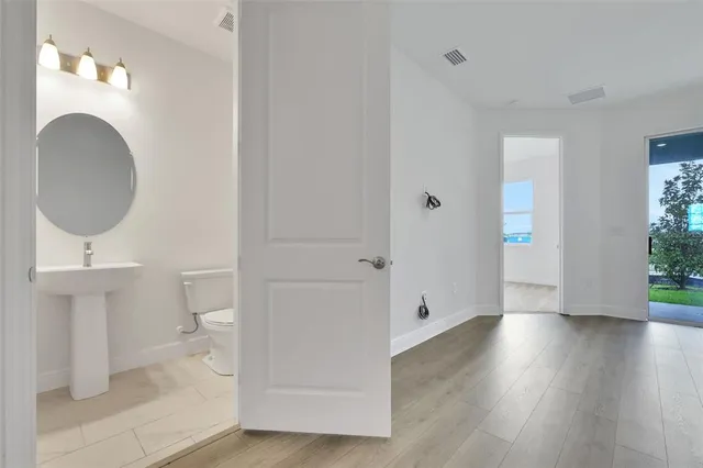 a bathroom with a toilet a sink and mirror