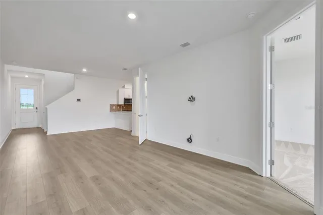 a view of a room with wooden floor and window