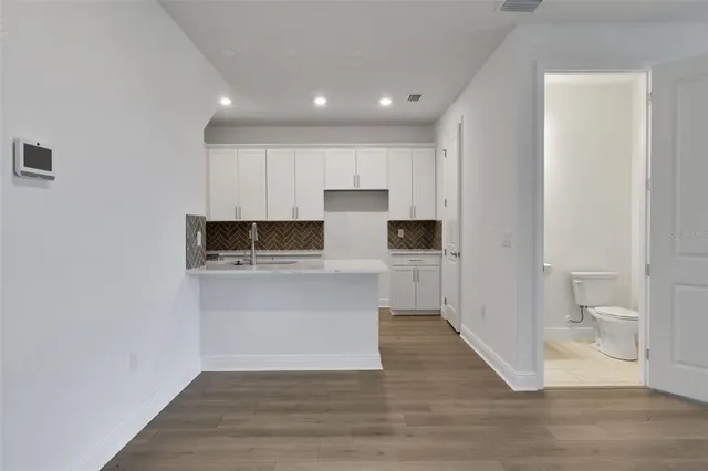 a view of a kitchen with a sink and a large window