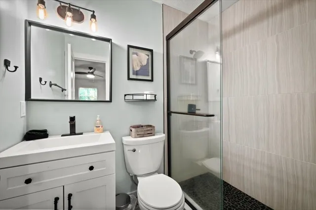 a bathroom with a toilet sink and shower