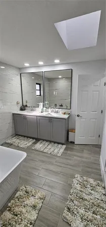 a living room with granite countertop furniture and wooden floor