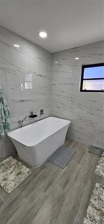 a bathroom with a bathtub and a shower