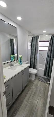 a bathroom with a double vanity sink toilet and mirror