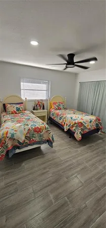 a bedroom with two beds and a lamp