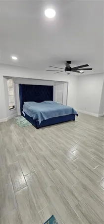 a bedroom with a bed and a night stand