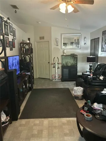 a living room with furniture and a mirror