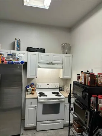 a kitchen with a stove and a refrigerator