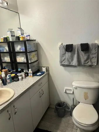 a white toilet sitting next to a shower