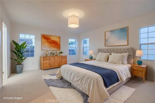 a bedroom with a bed and a potted plant