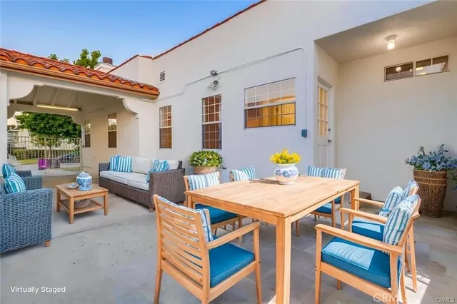 a backyard of a house with table and chairs