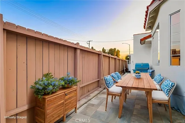 a view of a dining room with furniture and a potted plant
