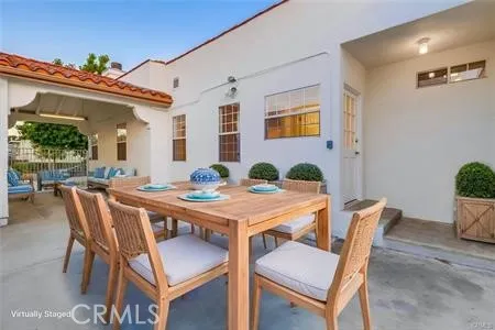 a kitchen with stainless steel appliances granite countertop a refrigerator a sink dishwasher a stove and white cabinets with wooden floor