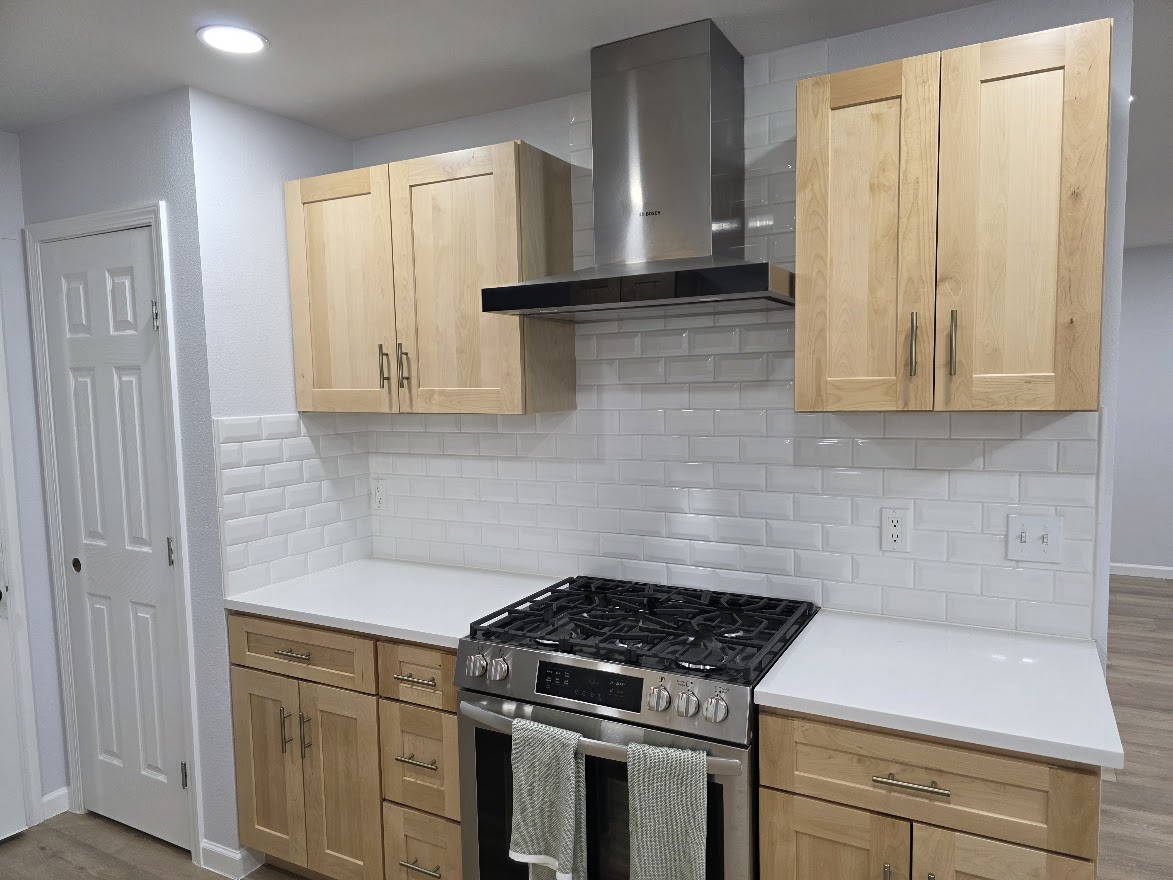 4803 Peach Grove Road Austin, TX 78744 - Photo 22 of 22 a kitchen with granite countertop white cabinets and white appliances