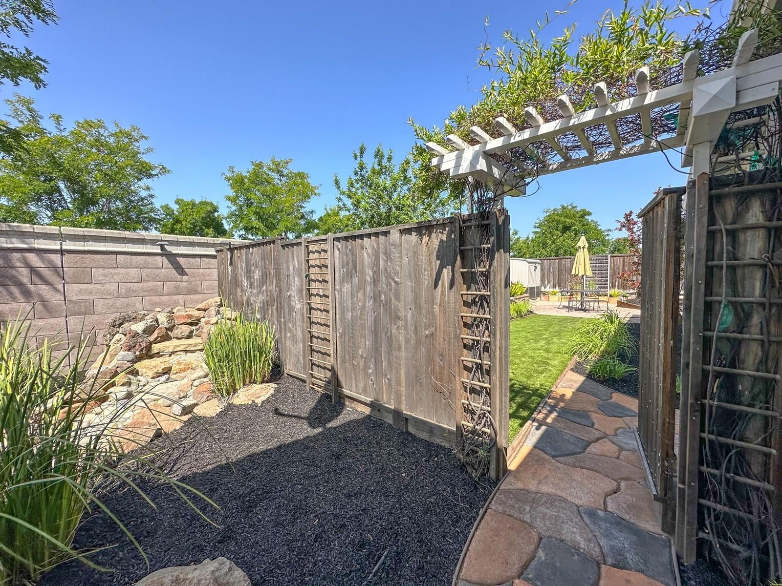 9901 Pyramid Way Discovery Bay, CA 94505 - Photo 11 of 53 a view of a garden with wooden fence