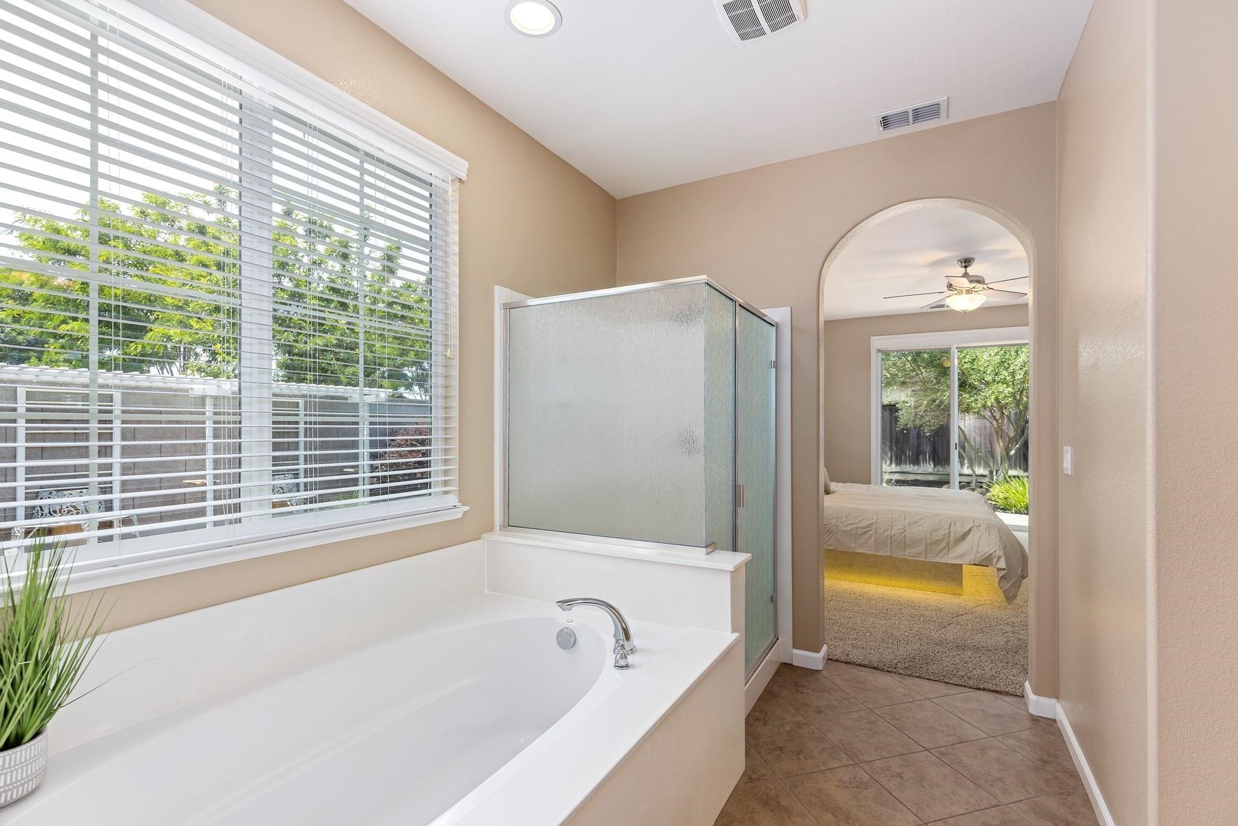 9901 Pyramid Way Discovery Bay, CA 94505 - Photo 27 of 53 a bathroom with a tub a sink and a window