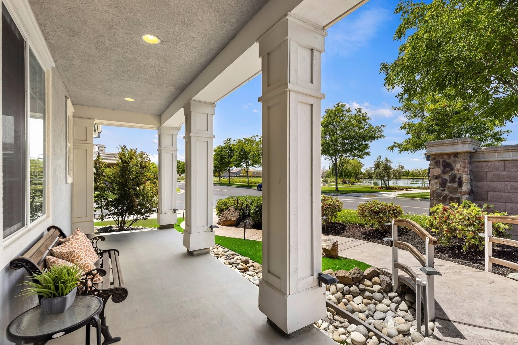9901 Pyramid Way Discovery Bay, CA 94505 - Photo 4 of 53 a porch with a table and chairs and potted plants
