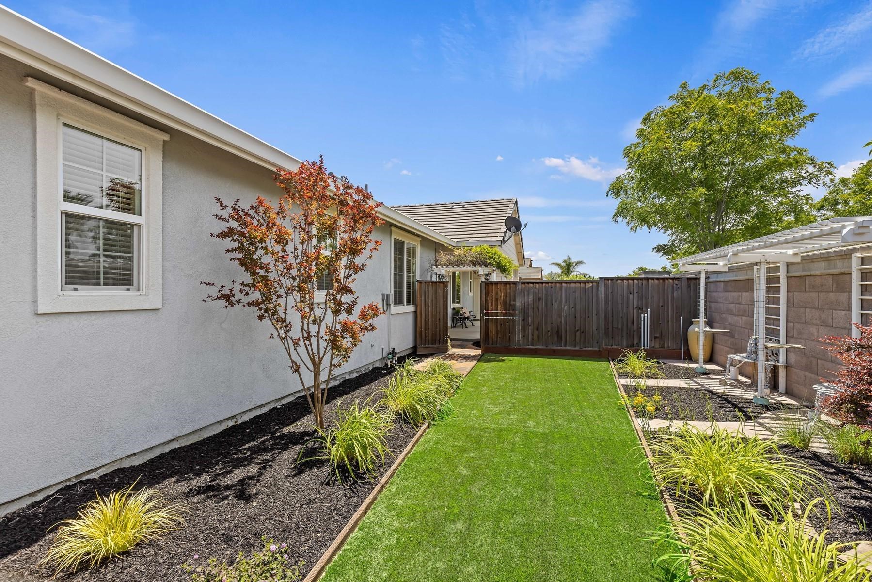 9901 Pyramid Way Discovery Bay, CA 94505 - Photo 44 of 53 a view of a backyard with table and chairs and wooden fence