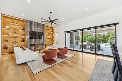 a living room with patio furniture and a large window