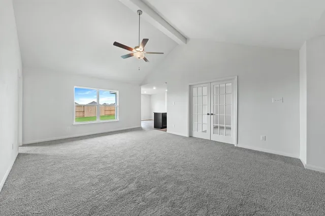 a view of empty room with windows and ceiling fan view