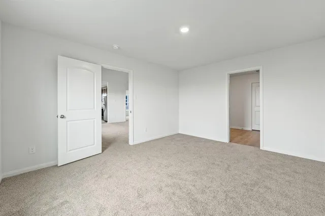 a view of an empty room and closet area