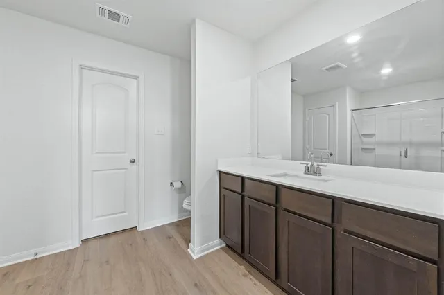a bathroom with a double vanity sink and mirror