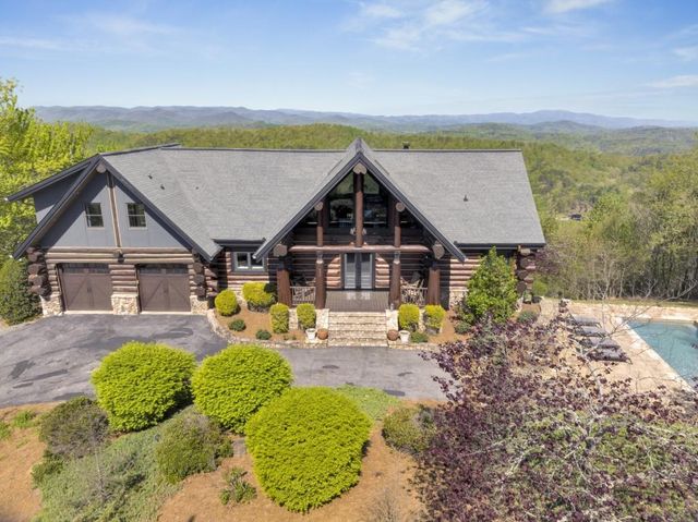 a view of house with outdoor space and sitting area