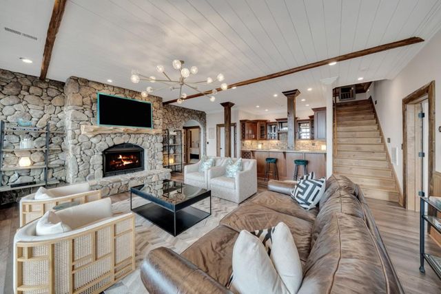 a living room with furniture a fireplace and a flat screen tv