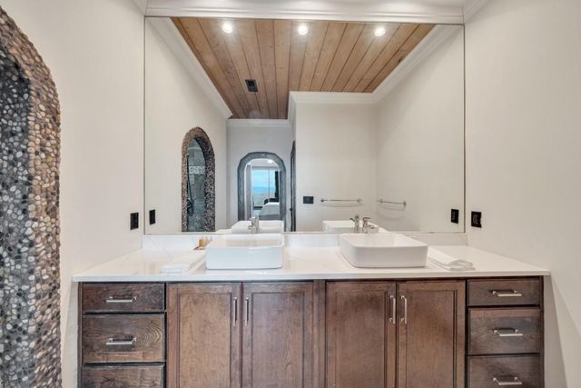 a bathroom with a double vanity sink and mirror