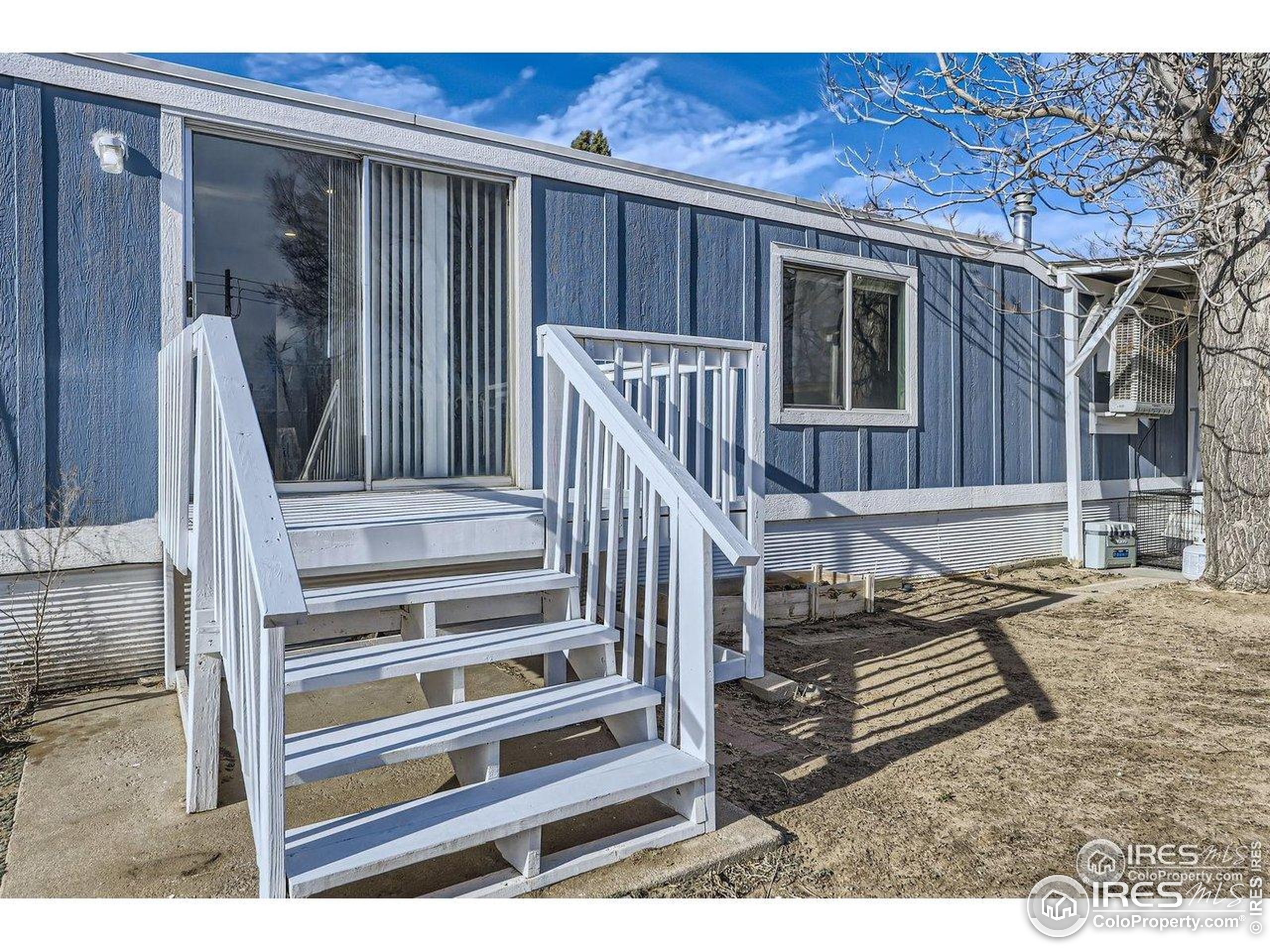 3500 35th Avenue, Unit 3 Greeley, CO 80634 - Photo 2 of 27 a view of wooden balcony and front door