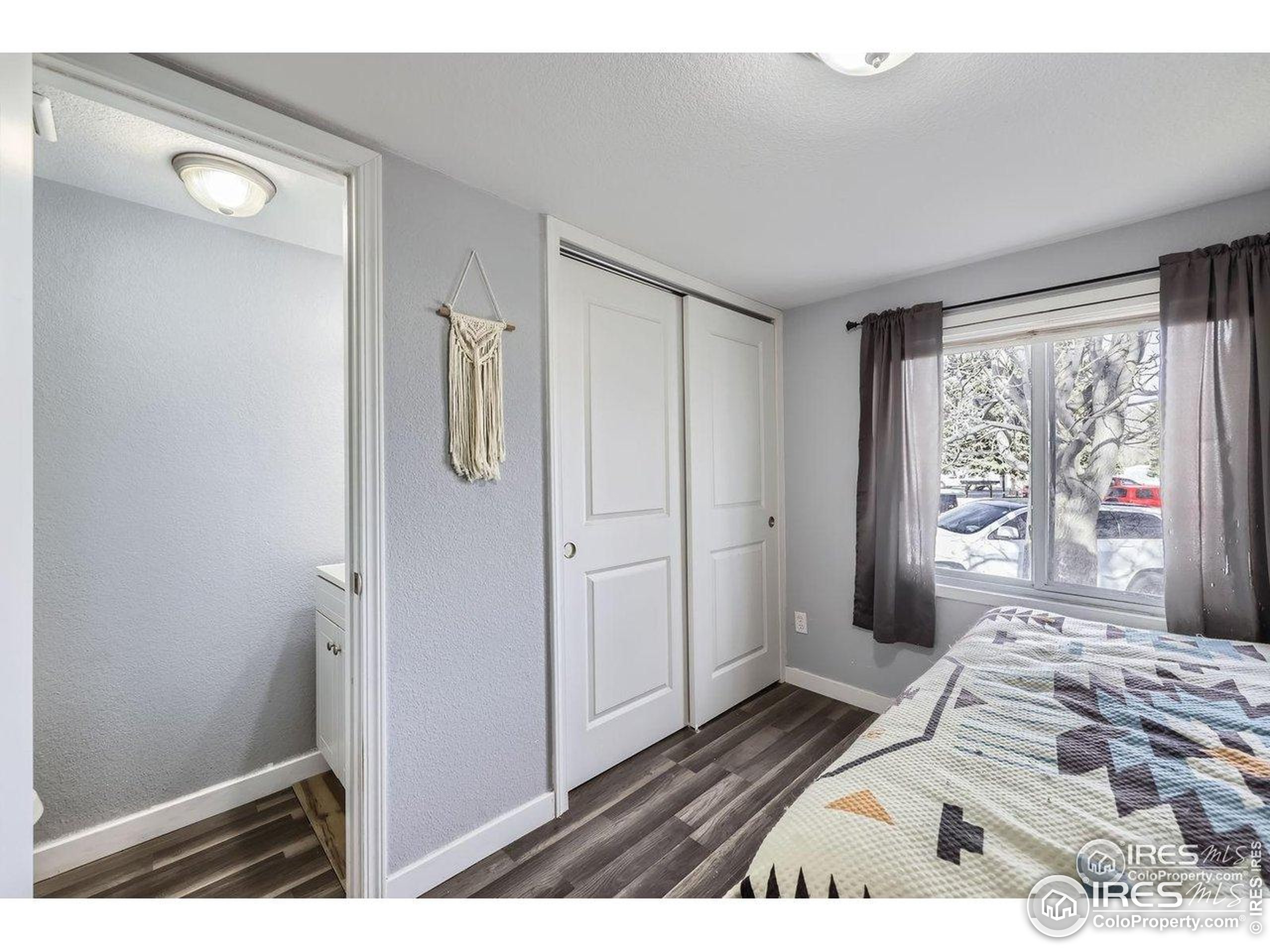 3500 35th Avenue, Unit 3 Greeley, CO 80634 - Photo 21 of 27 a bedroom with a bed and a large window