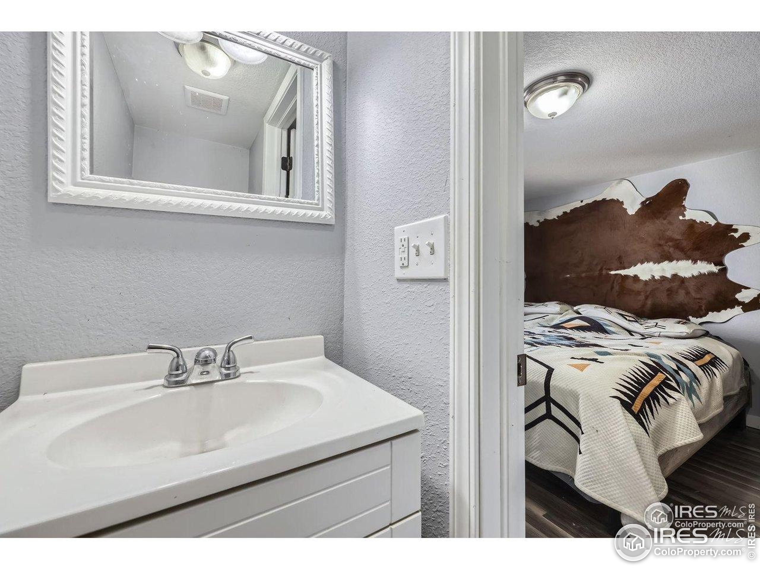 3500 35th Avenue, Unit 3 Greeley, CO 80634 - Photo 22 of 27 a bathroom with a sink and a mirror