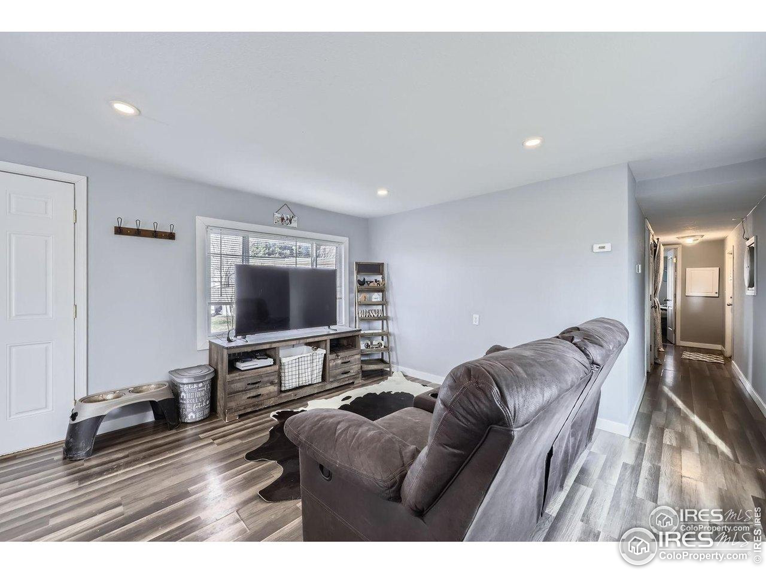 3500 35th Avenue, Unit 3 Greeley, CO 80634 - Photo 9 of 27 a living room with furniture and a flat screen tv