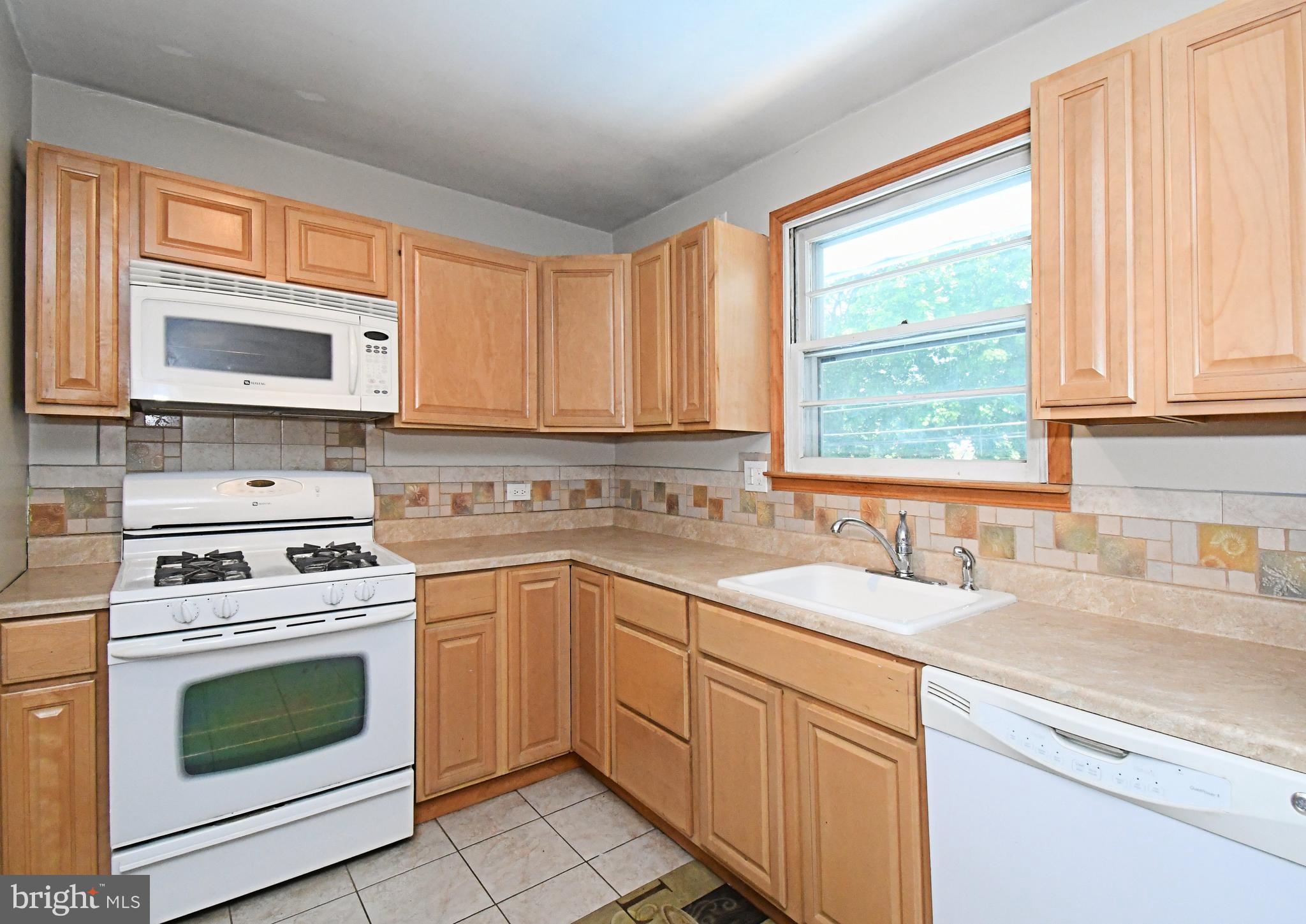 609 Mansfield Road Willow Grove, PA 19090 - Photo 14 of 68 a kitchen with granite countertop a sink cabinets stainless steel appliances and a window