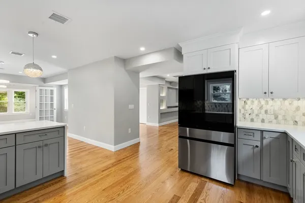 a kitchen with stainless steel appliances granite countertop a refrigerator and a sink