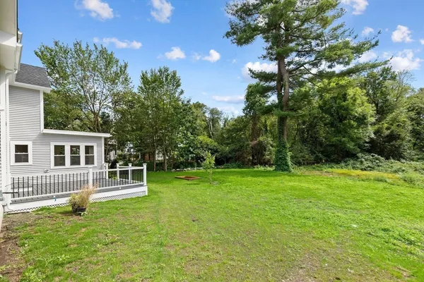 a backyard of a house with table and chairs