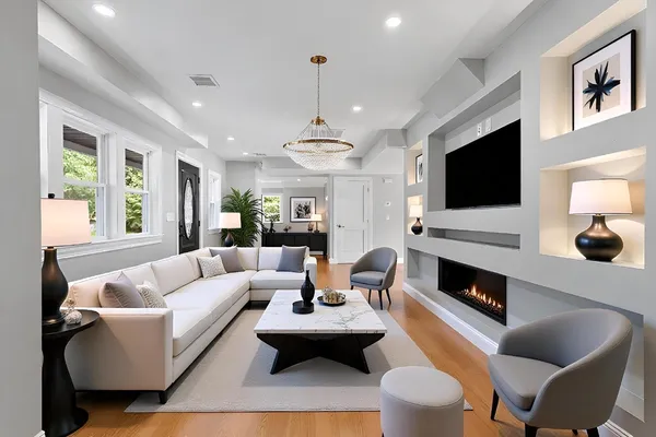 a living room with furniture a flat screen tv and a fireplace