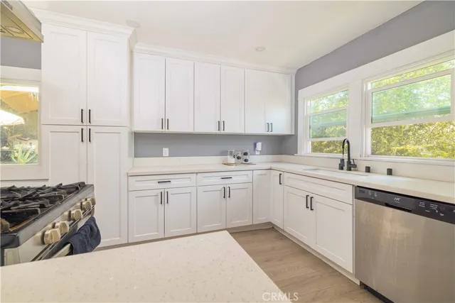 a kitchen that has a sink and a stove in it
