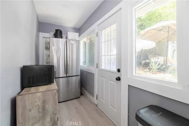a kitchen with stainless steel appliances a refrigerator and a window