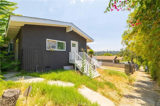 a house view with swimming pool and garden