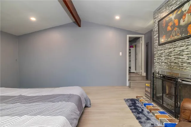 a bedroom with a bed and a fireplace