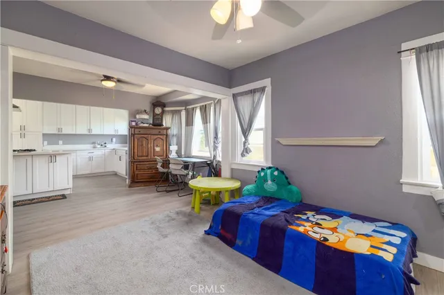 a spacious bedroom with a bed and a chandelier