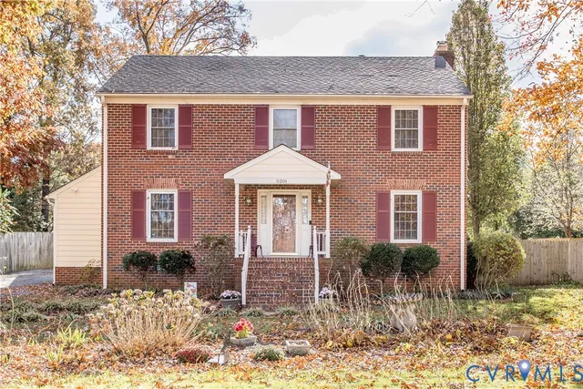 a front view of a house with a yard and outdoor seating