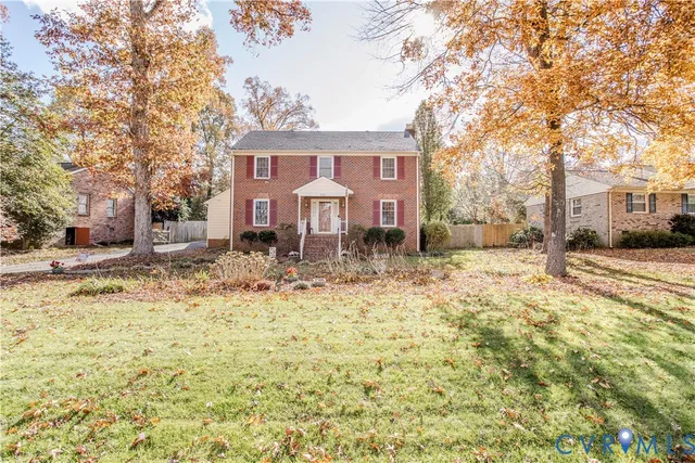 a front view of a house with a yard covered with snow