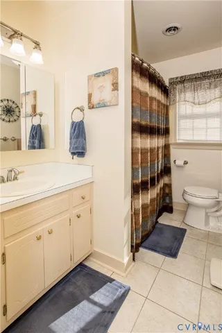 a spacious bathroom with double vanity and a shower