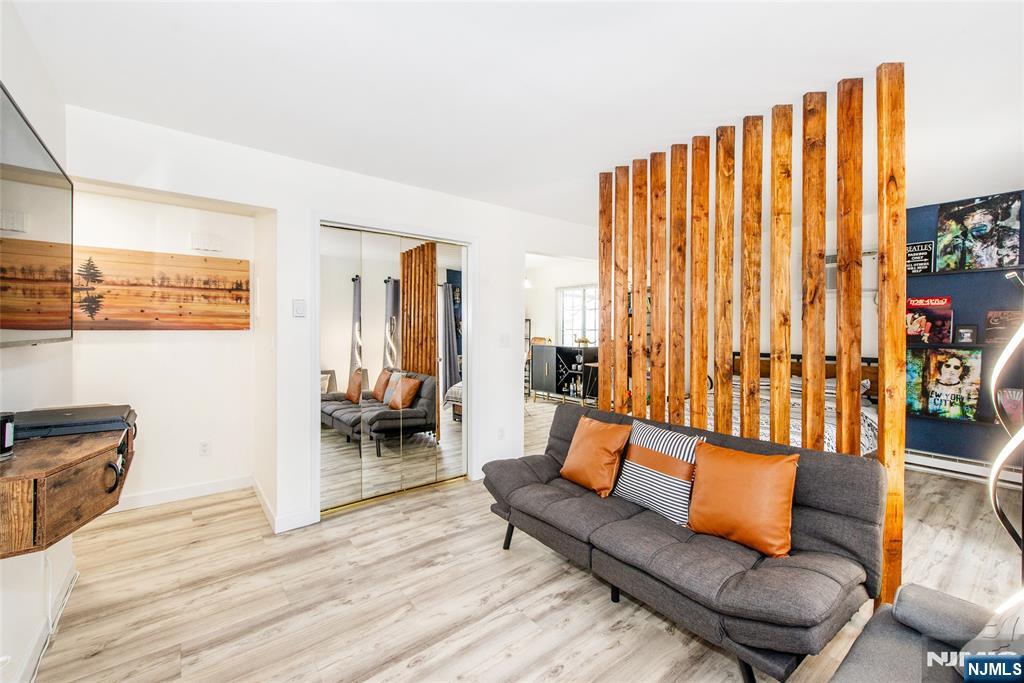 79 Getty Avenue, Unit 4B Clifton, NJ 07011 - Photo 14 of 30 a living room with furniture and a large window