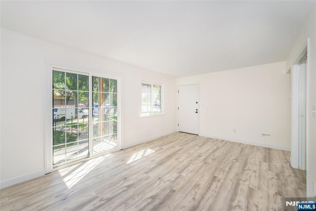 79 Getty Avenue, Unit 4B Clifton, NJ 07011 - Photo 17 of 30 an empty room with wooden floor and windows