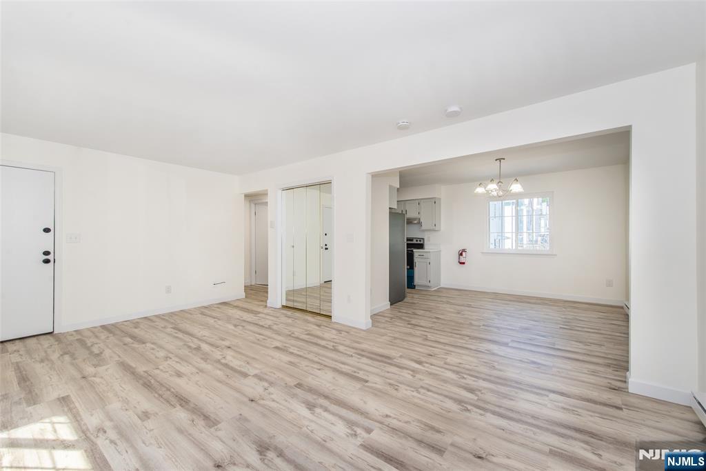 79 Getty Avenue, Unit 4B Clifton, NJ 07011 - Photo 19 of 30 a view of an empty room with wooden floor and a window