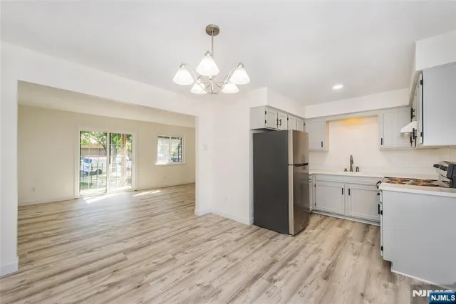 a open kitchen with stove and refrigerator